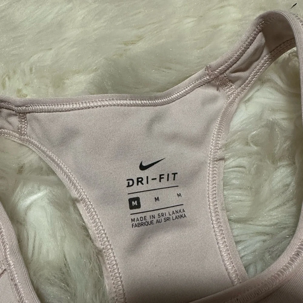 Nike Women's Light Pink Sports Bra with glitter logo. Has tiny stitch pictured!